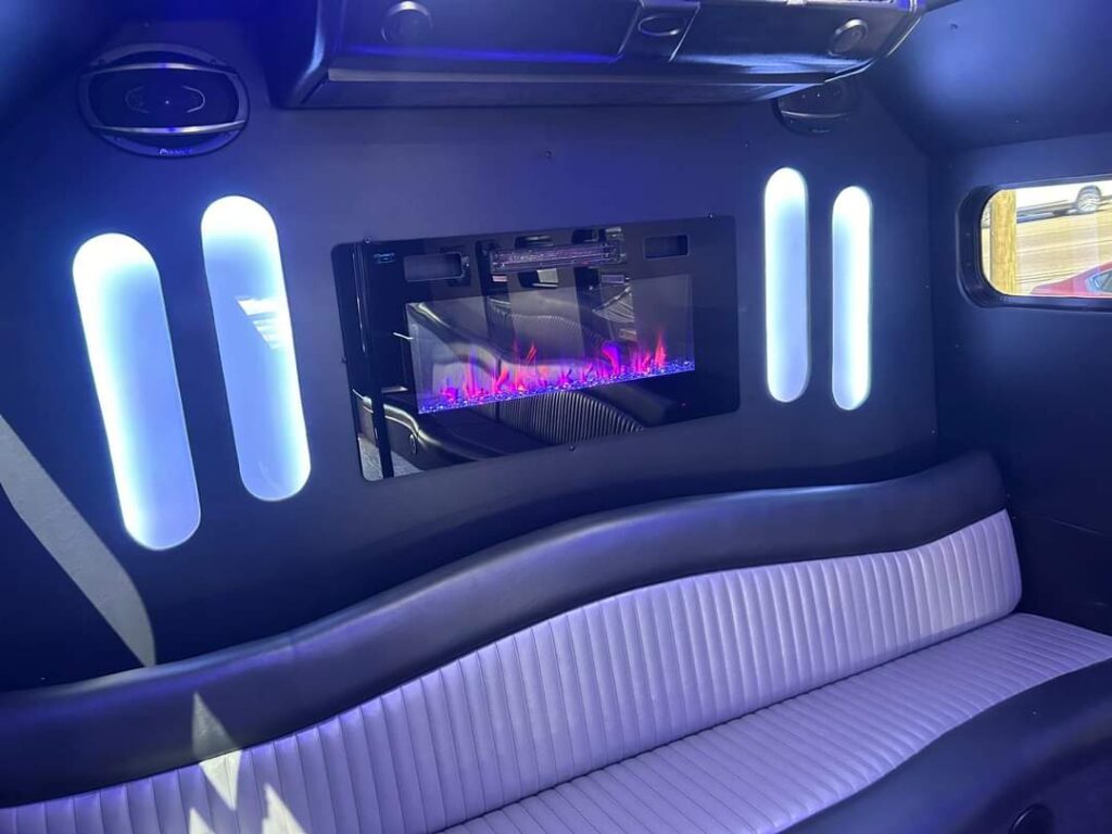 Curved limo seat with glowing wall lights, purple flames—perfect for a bachelorette party ride.