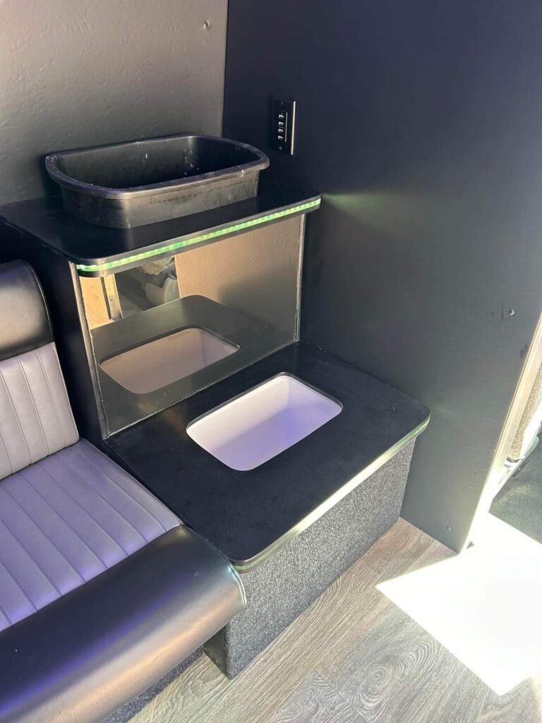 Small black sink, white basin below—perfect for a Wisconsin Limo Bus bachelorette party night.