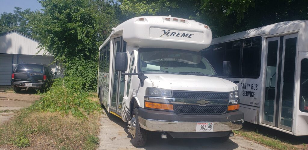 White Xtreme Party Bus Service bus parked outside, ideal for a bachelor party or wedding shuttle.