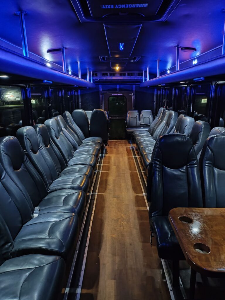 Empty, blue-lit Wisconsin bus interior—ideal for a bachelor party or cozy wedding shuttle ride.